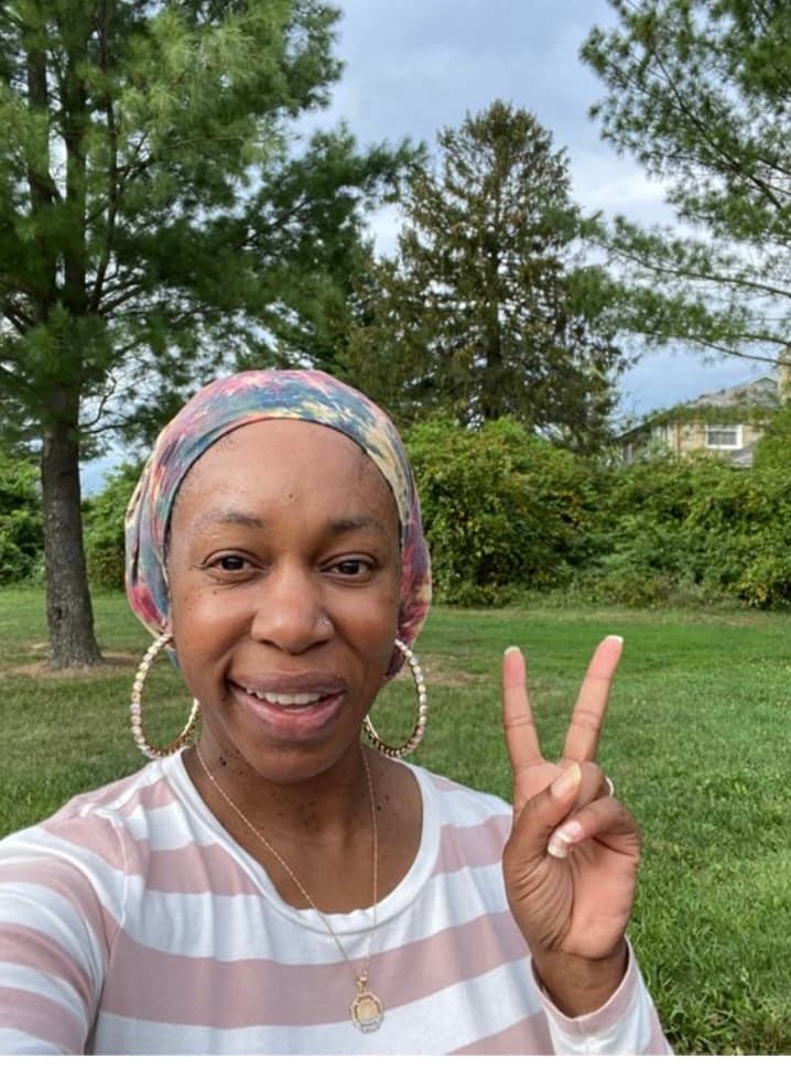 women holding the peace sign outside